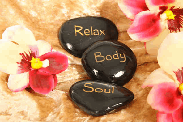 Hot stones with the words relax, body and soul on them