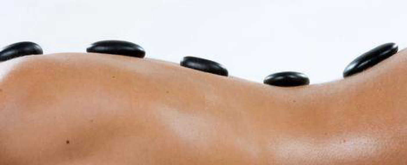 Side view of woman having a hot stone massage
